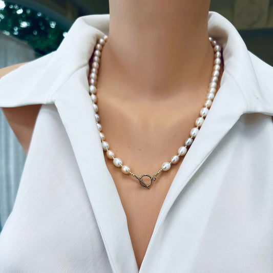 Pastel pearl necklace worn on mannequin, frontal view