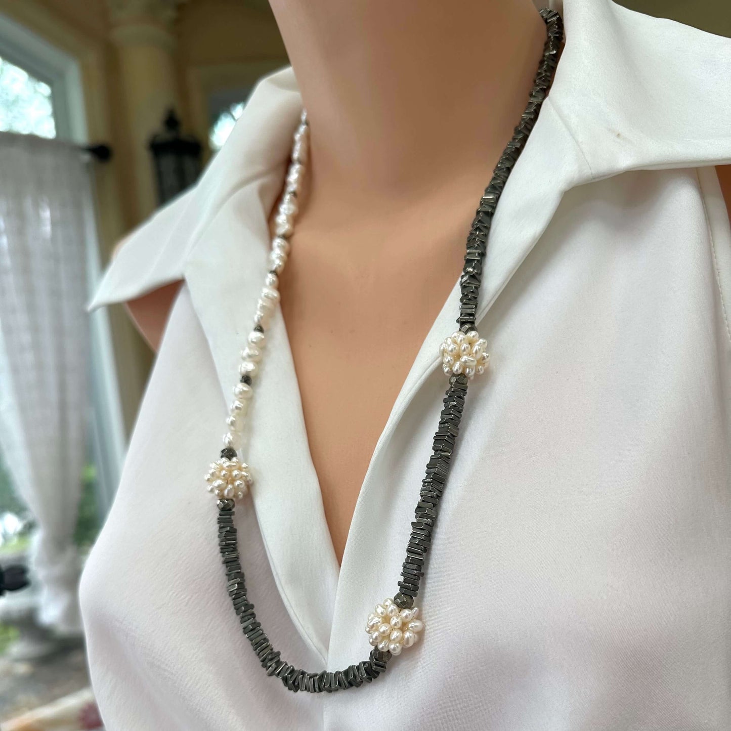 Pyrite and pearl necklace displayed on mannequin, side angle