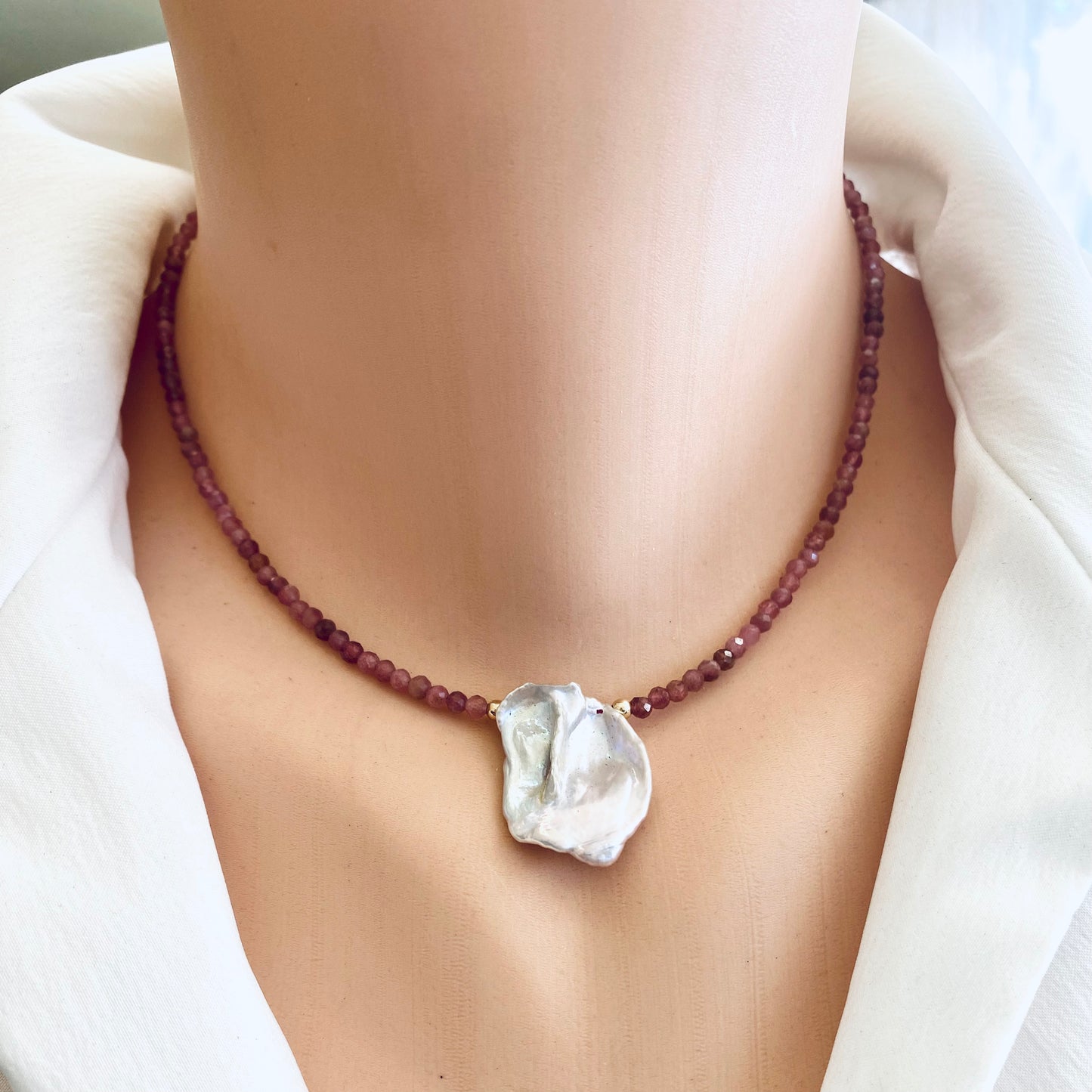 Pink tourmaline keshi pearl choker necklace worn on model with natural pearl centerpiece