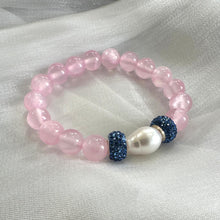 Load image into Gallery viewer, Pink jade bracelet featuring 10mm jade beads, freshwater pearl, and rhinestone accents on a soft fabric background.
