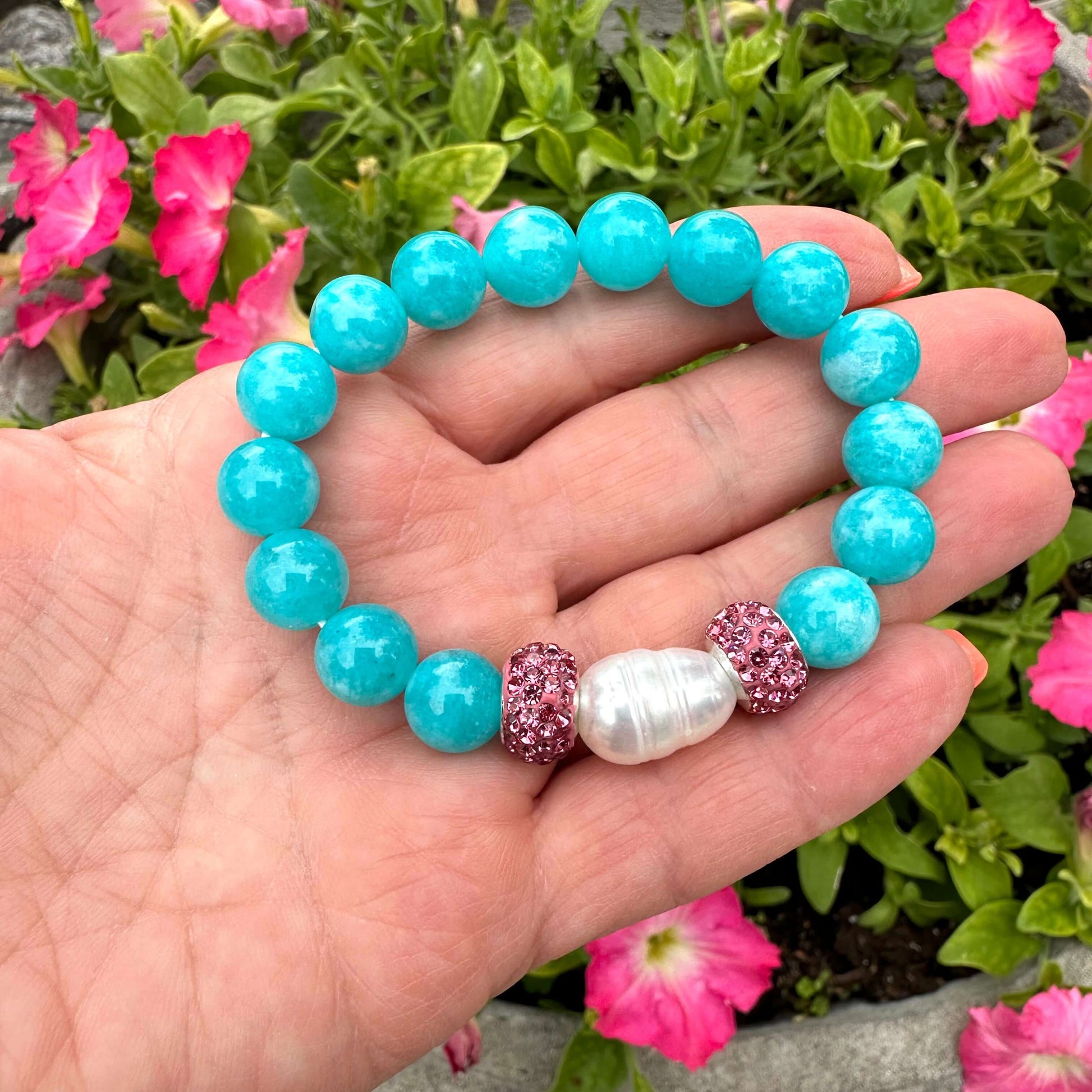 Teal jade bracelet with pearls, featuring 10mm teal blue jade beads, freshwater pearl, and pink rhinestone accents.