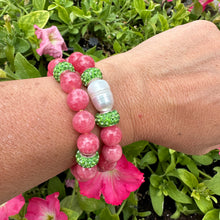 Load image into Gallery viewer, Two red jade bracelets with green rhinestones, one with a pearl, worn on a woman’s wrist
