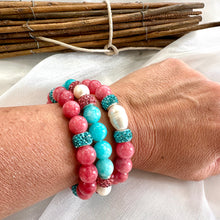 Load image into Gallery viewer, Teal jade bracelet with pearls and pink accents worn on a wrist, showcasing handmade jewelry craftsmanship.
