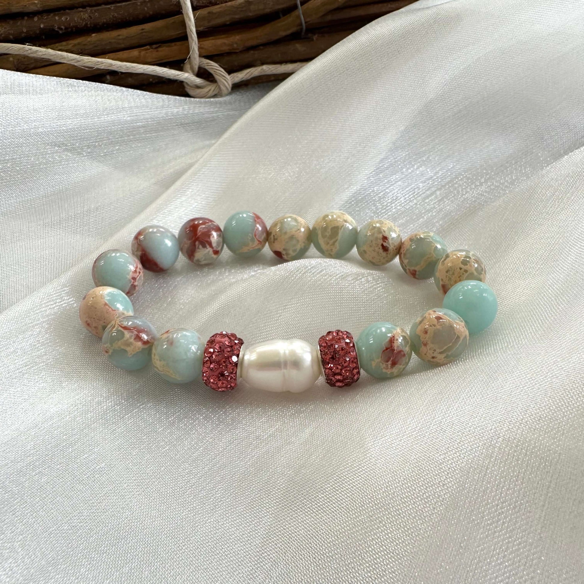 Blue opal jasper bracelet displayed on white cloth background