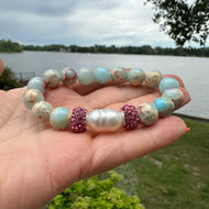 Close up of blue opal jasper bracelet outdoors with greenery