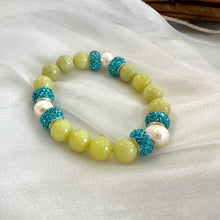 Load image into Gallery viewer, Olive green jade bracelet with three pearls displayed on white cloth
