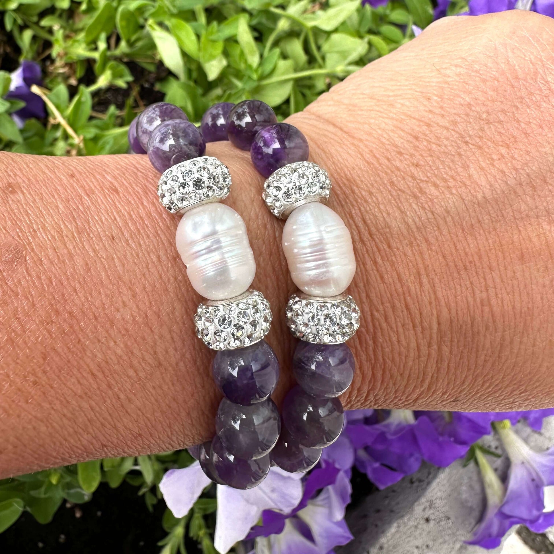 Chevron amethyst bracelet worn on female wrist with stacked bracelets