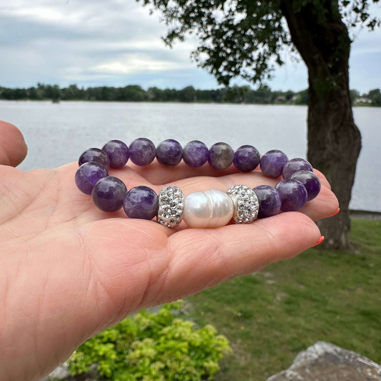 Chevron amethyst bracelet held in hand in natural outdoor light