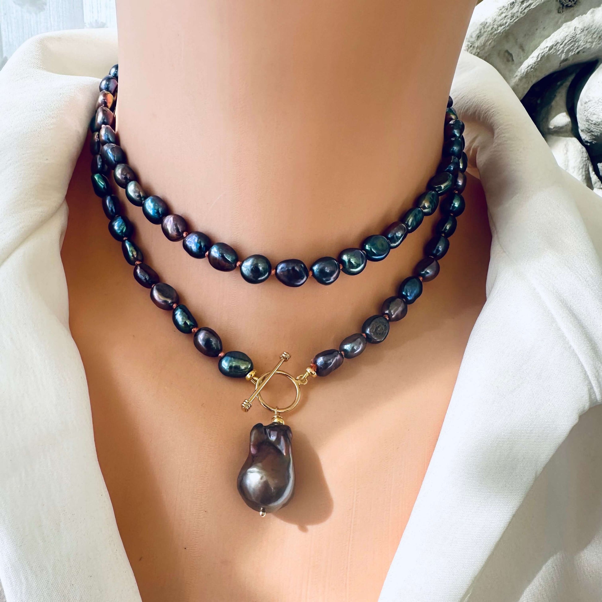Peacock black pearl necklace with baroque pendant worn as a choker on mannequin