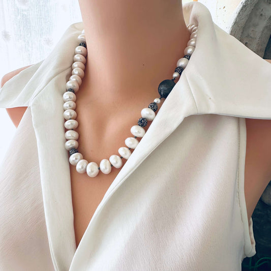White button pearl necklace with rhinestone beads displayed on mannequin, frontal close-up
