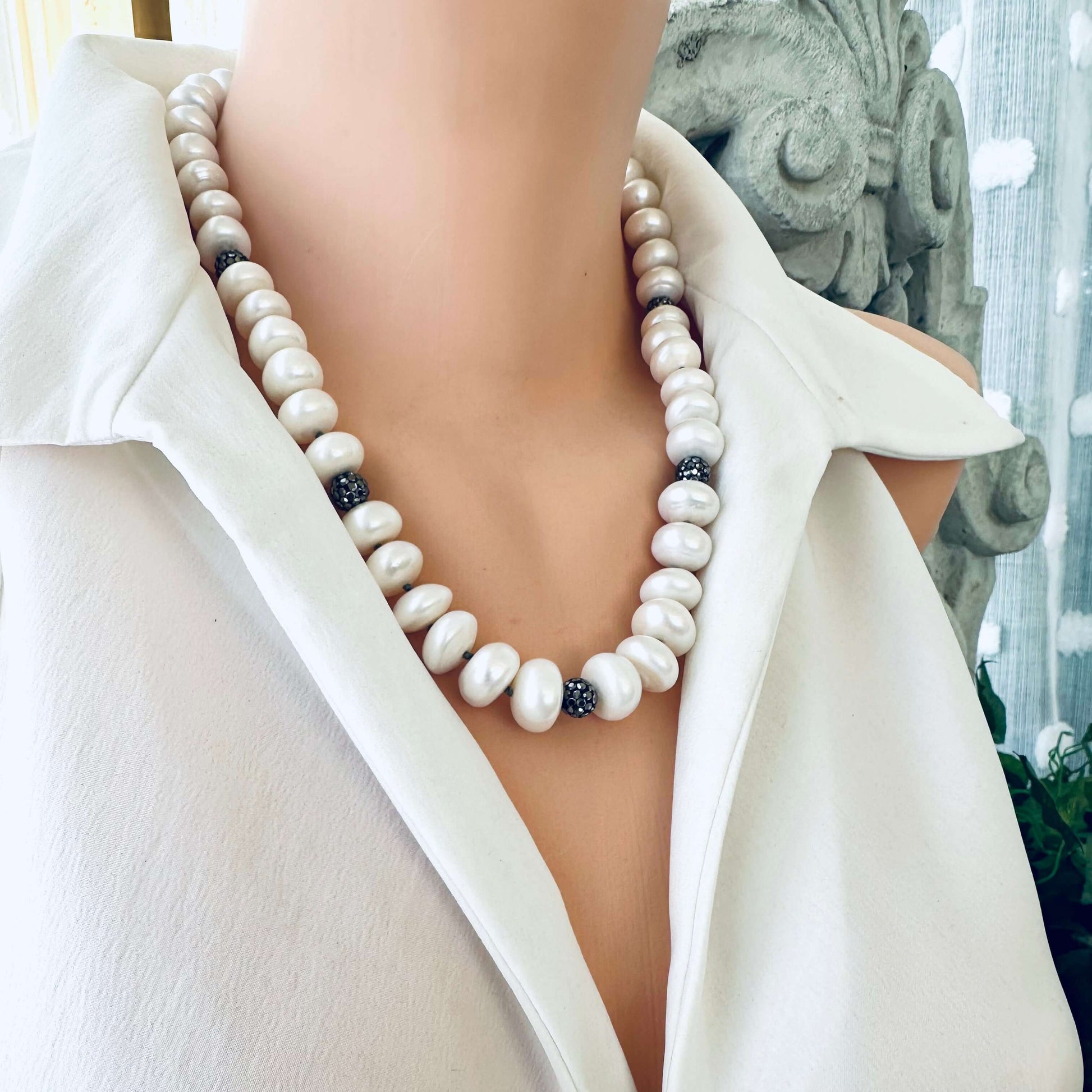 White button pearl necklace with rhinestone beads on mannequin, studio lighting
