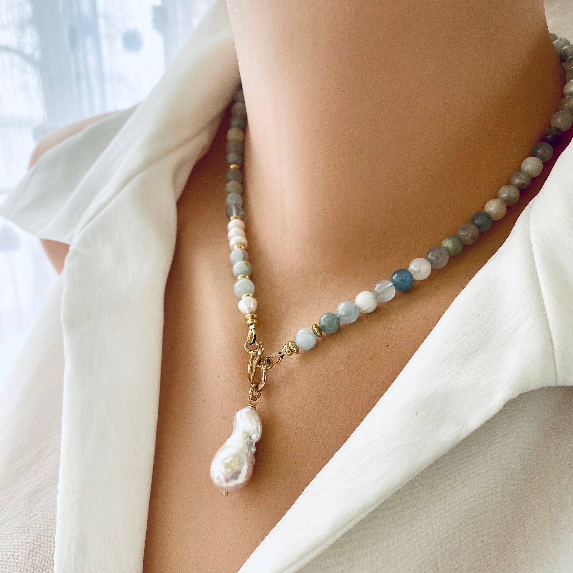 Aquamarine pearl necklace on mannequin showing baroque pearl pendant