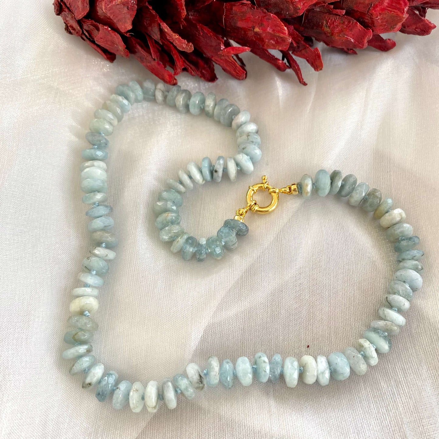Aquamarine beaded necklace displayed on white cloth