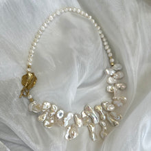 Charger l&#39;image dans la galerie, Stunning 19&quot; white Keshi pearls necklace, featuring a unique asymmetrical design that showcases both petal-shaped and nugget pearls with a beautiful golden vine leaf toggle clasp making this necklace not only easy to wear but a striking focal point.
