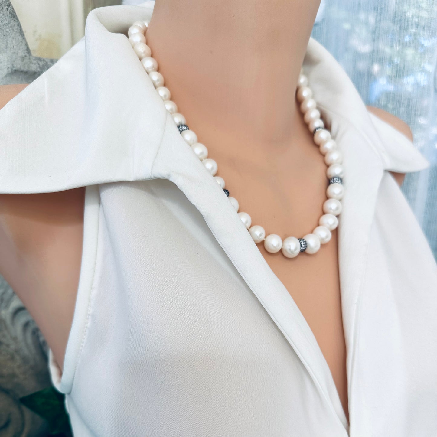 Pearl necklace with zircon pave beads showcased on a mannequin, handcrafted in Canada, blending elegance and sophistication.