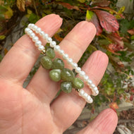 Double wrap pearl bracelet featuring creamy freshwater pearls and olive-green Vesuvianite gemstones.