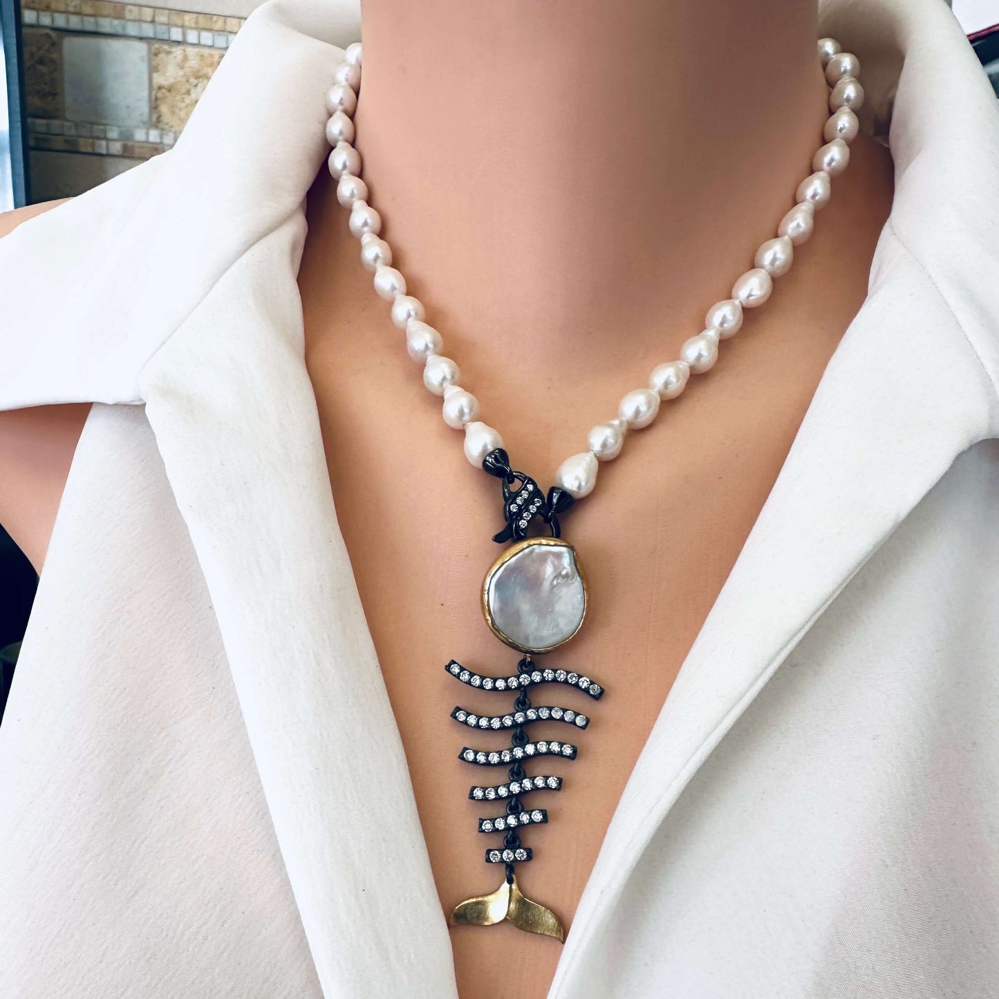 Small baroque pearl necklace with fishbone pendant on mannequin handmade in Canada