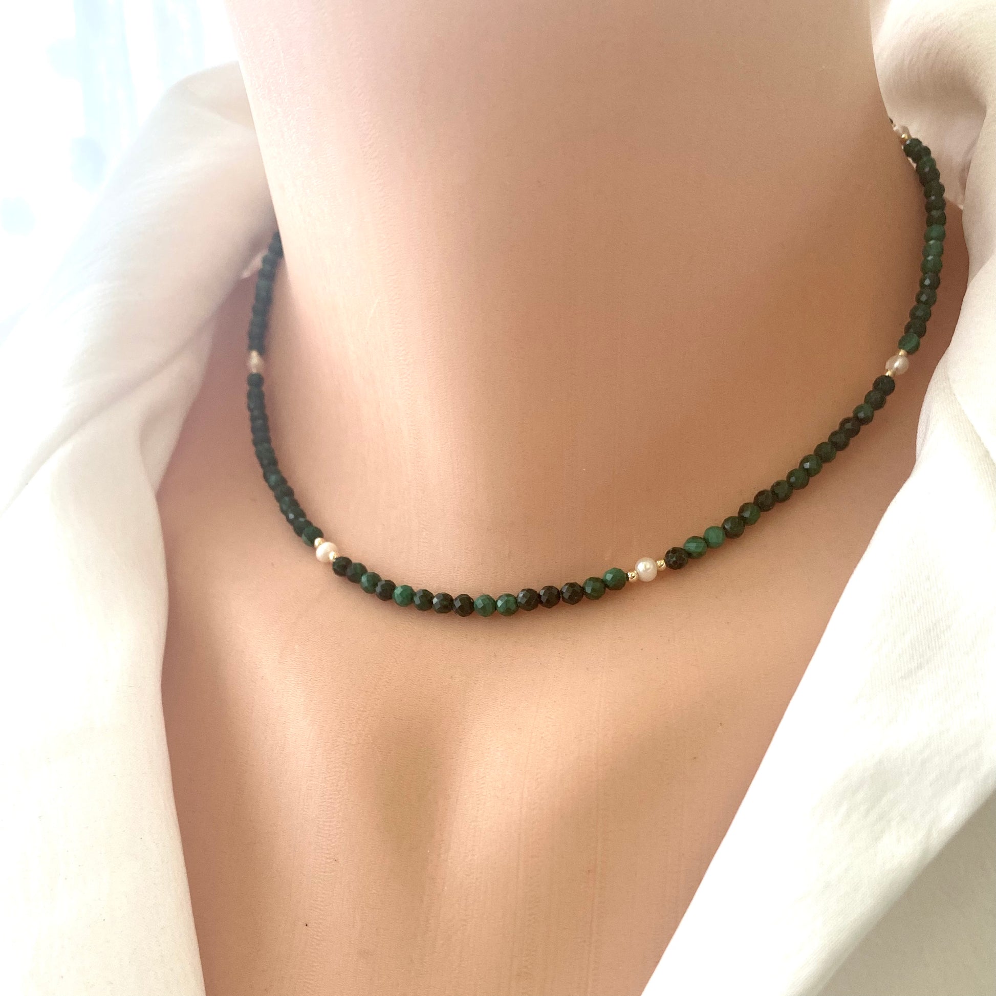 Malachite Pearl Choker Necklace featuring rich malachite beads and luminous freshwater pearls, worn elegantly on a model.