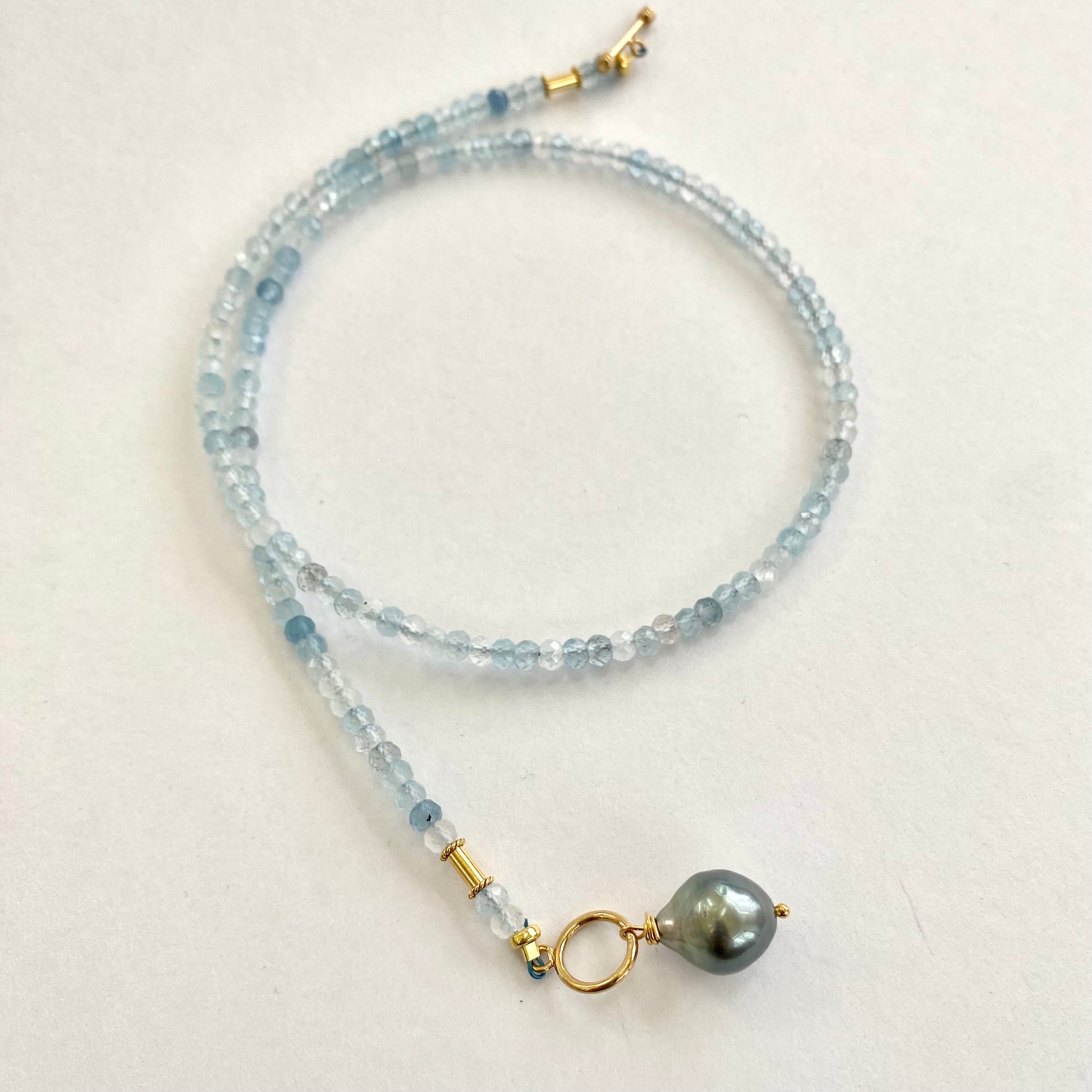 Aquamarine Pearl Pendant Necklace featuring faceted aquamarine beads and a Tahitian baroque pearl pendant.