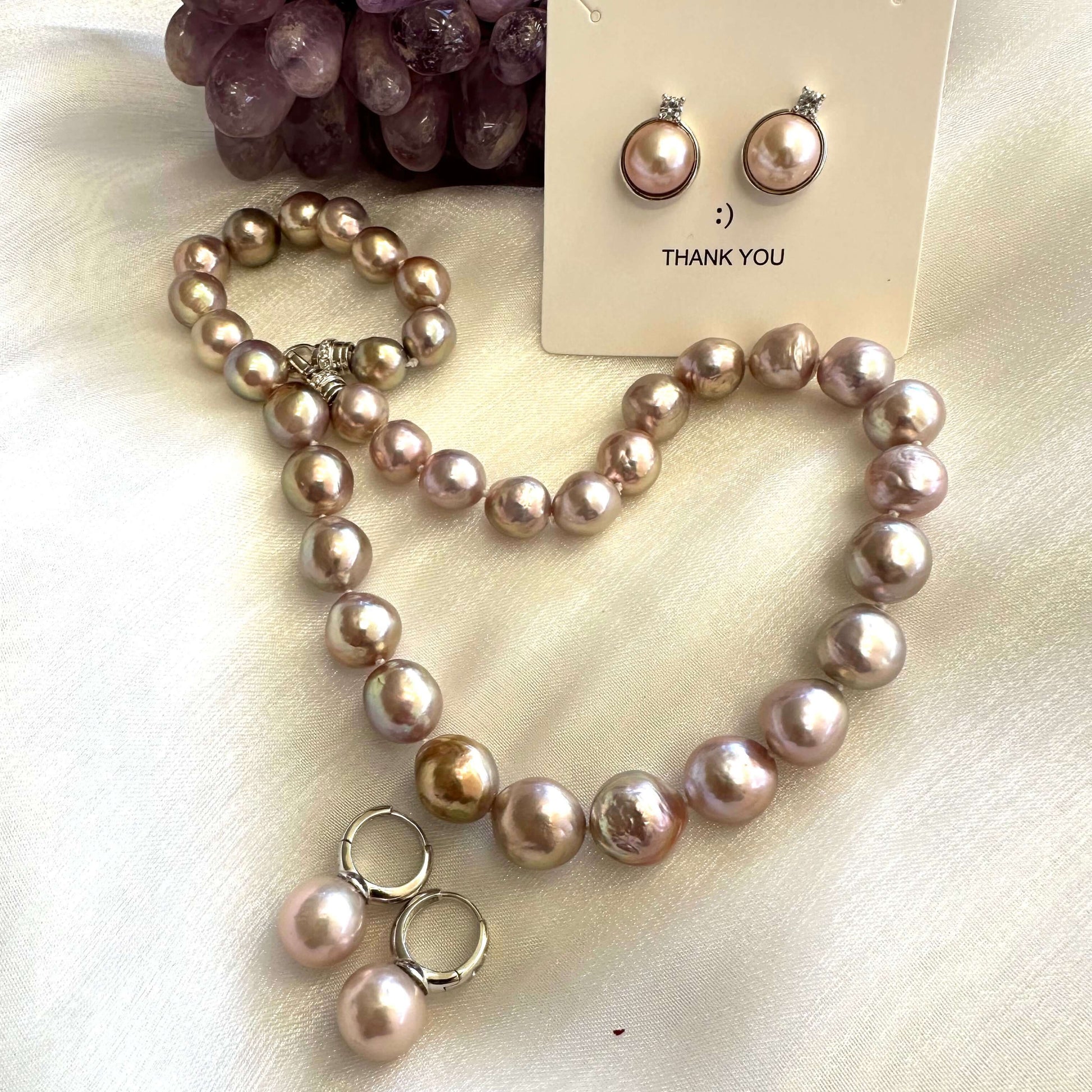 Light Pink Pearl Hoop Earrings – Edison Pearls, Silver with matching necklace and earrings on display.