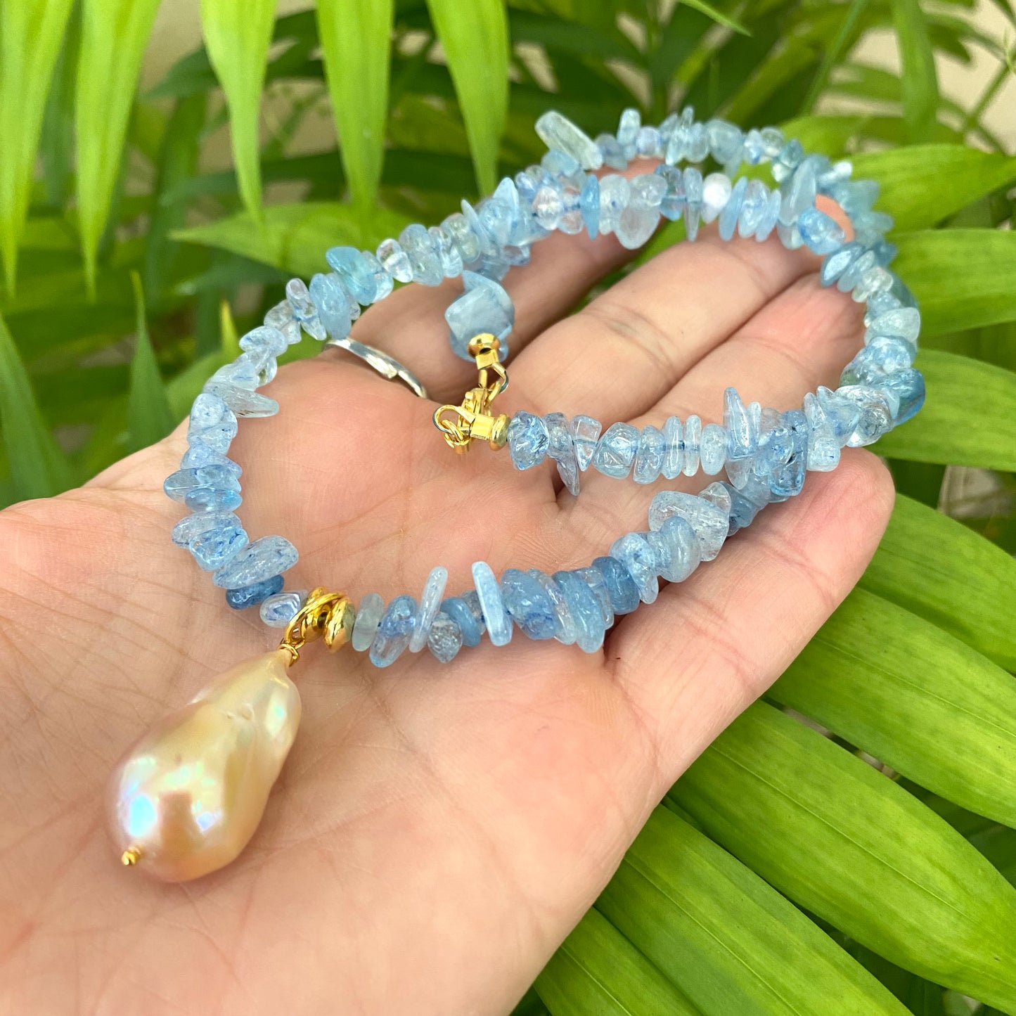 Aquamarine baroque pearl necklace featuring golden pink pearl pendant and cool Aquamarine beads.