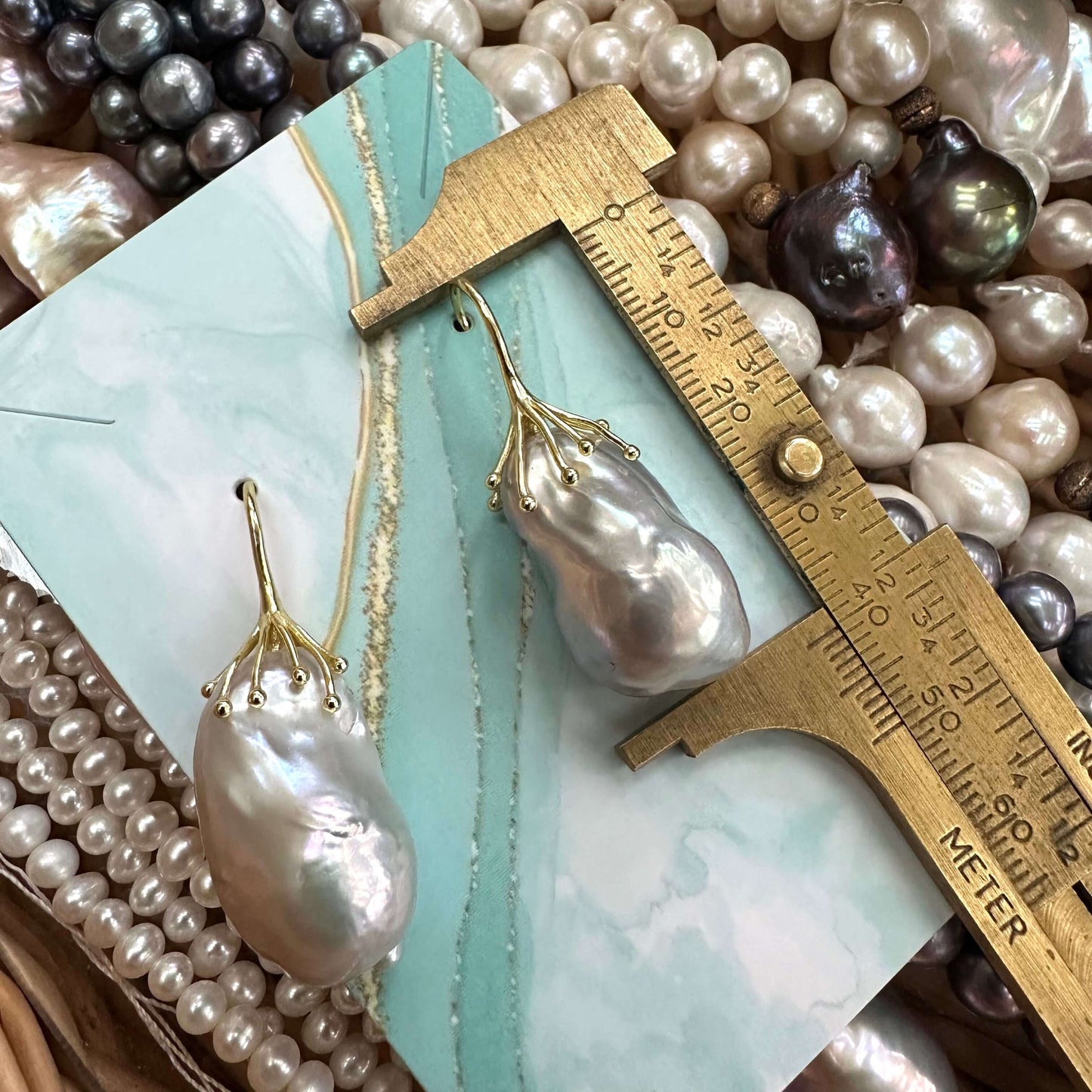 Gold vermeil silver grey baroque pearl drop earring measured against ruler including stud to display total drop length and design.