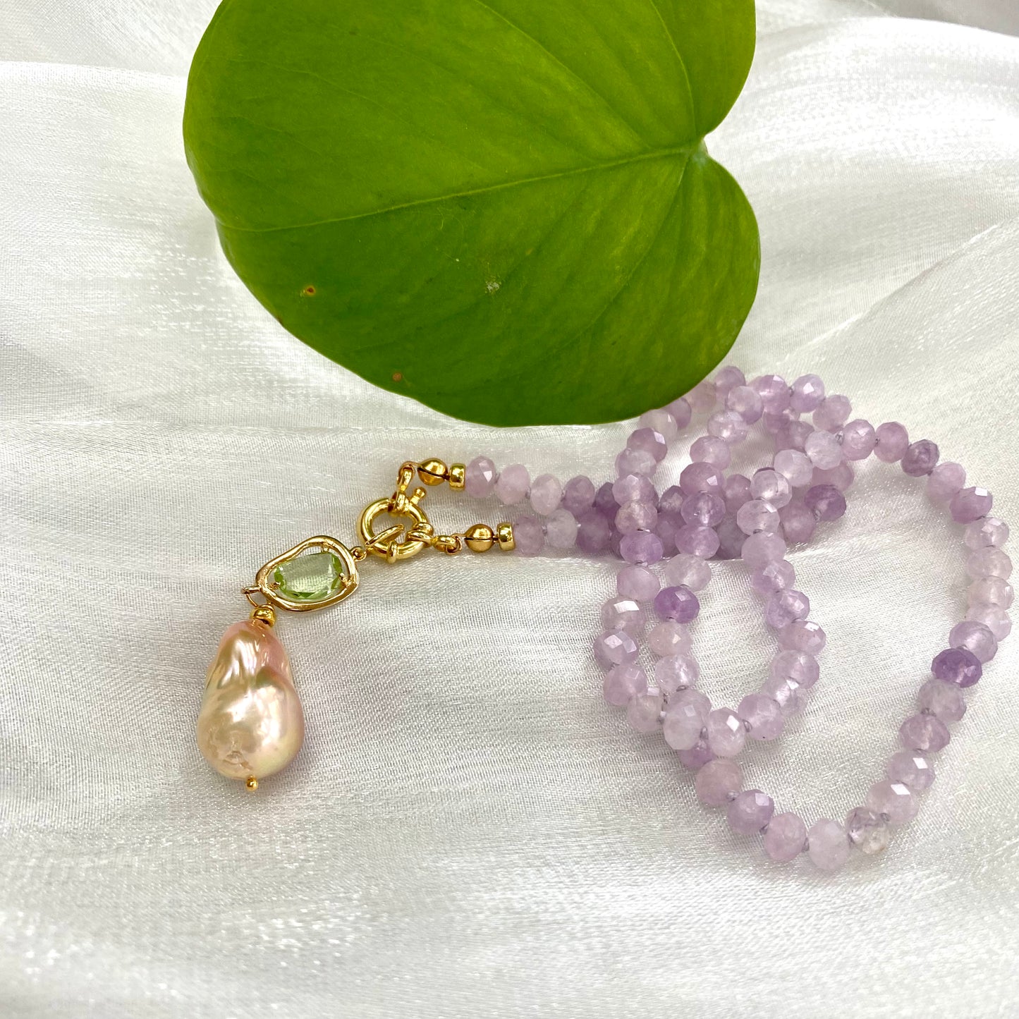 Lavender amethyst baroque pearl necklace with a Baroque pearl pendant and green accent, showcasing elegant candy-style design.