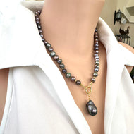 Handcrafted black pearl necklace with peacock luster and removable baroque pendant shown in side view