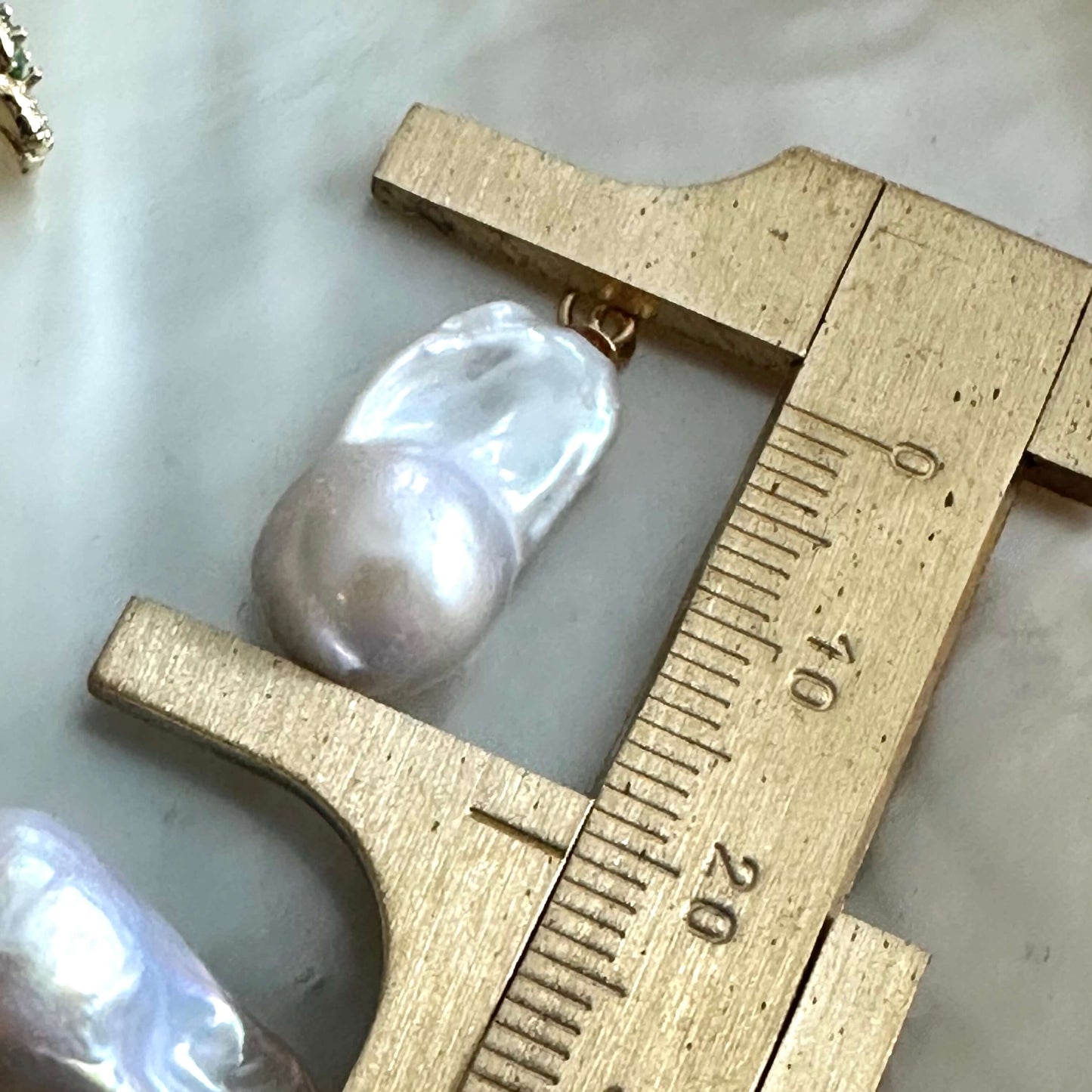 Chrome diopside baroque pearl earrings with pearl size measured by ruler
