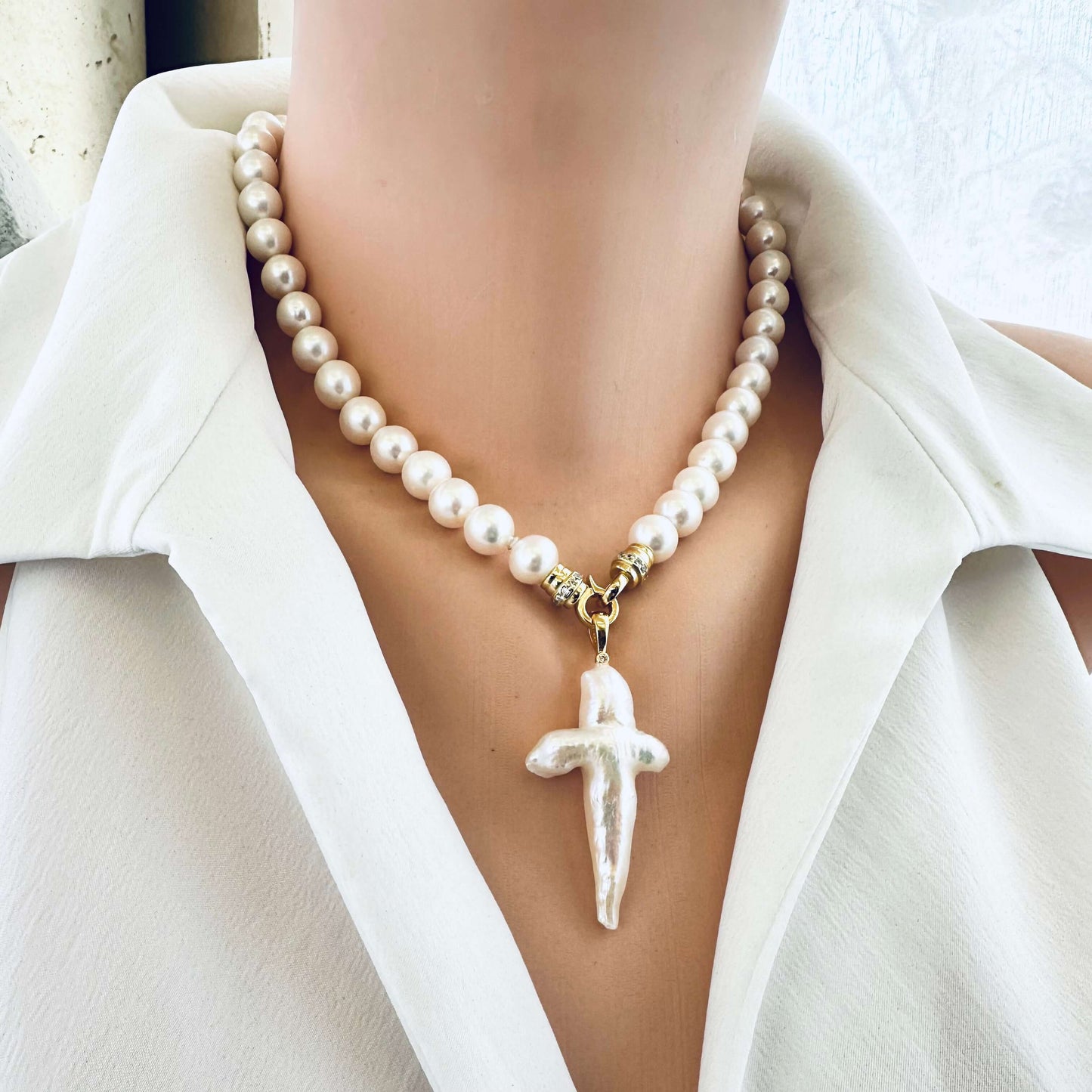 Front view of white pearl necklace cross pendant on mannequin — handcrafted pearl necklace with optional pendant by Loulia Pearl Jewelry