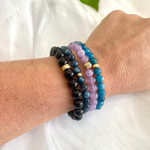 Load image into Gallery viewer, Blue Apatite Bracelet worn on woman’s wrist – layered with other bracelets
