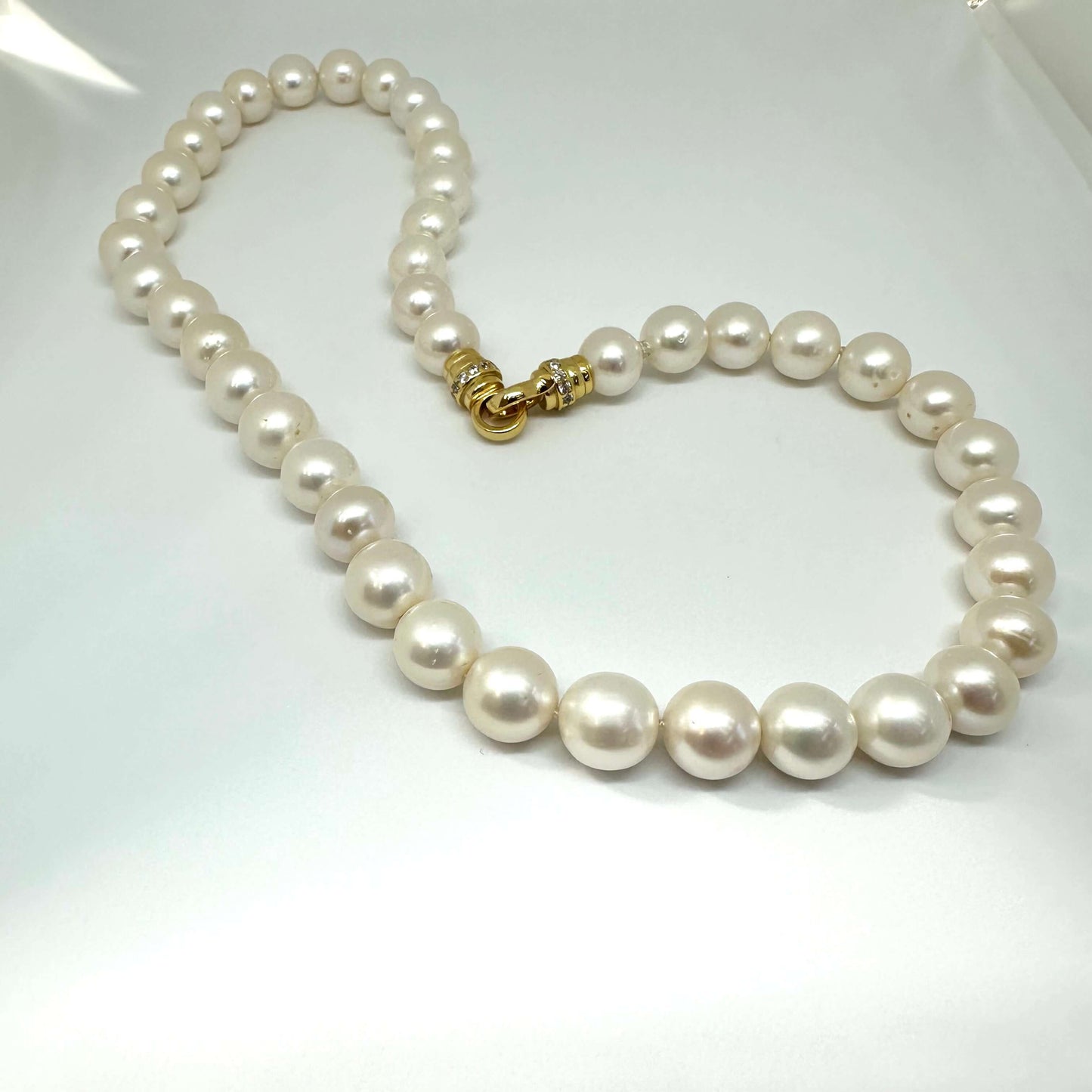Detailed view of white pearl necklace cross pendant without pendant — fine freshwater pearls with gold or silver clasp