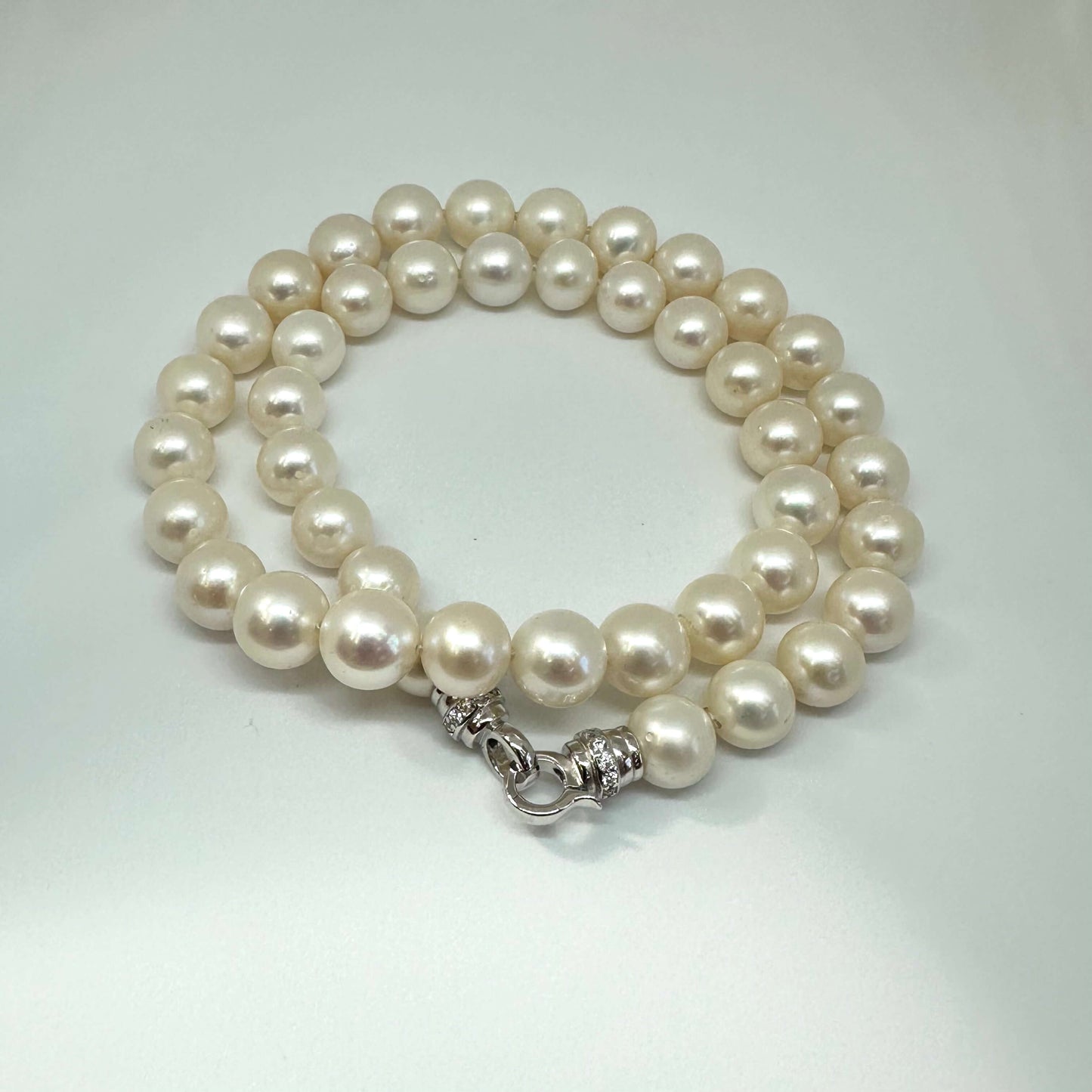 White pearl necklace cross pendant photographed on white backdrop — handcrafted classic pearl jewelry by Loulia Pearl Jewelry