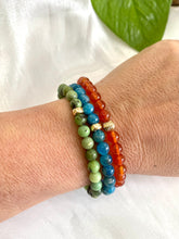 Load image into Gallery viewer, Blue Apatite Bracelet stacked with mixed bracelets on wrist – natural light shot
