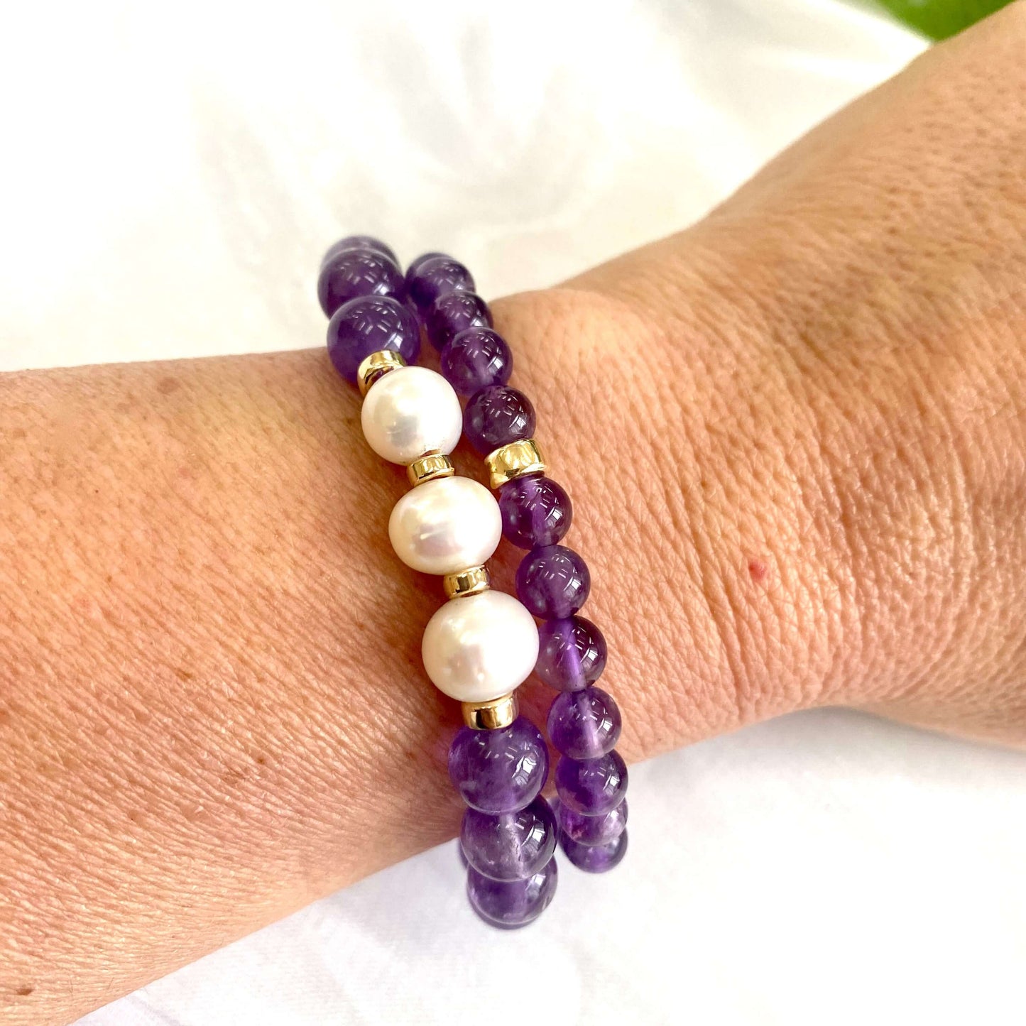 Amethyst Pearl Bracelet worn as a pair on woman’s wrist – two-bracelet shot