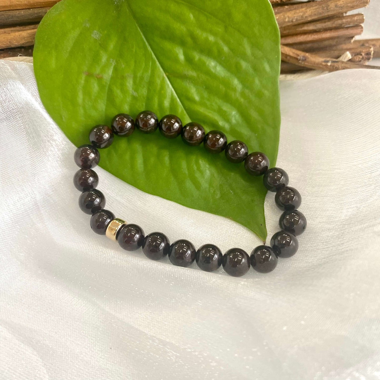 Dark Red Garnet Bracelet single-piece close-up on white cloth – gemstone and pearl detail
