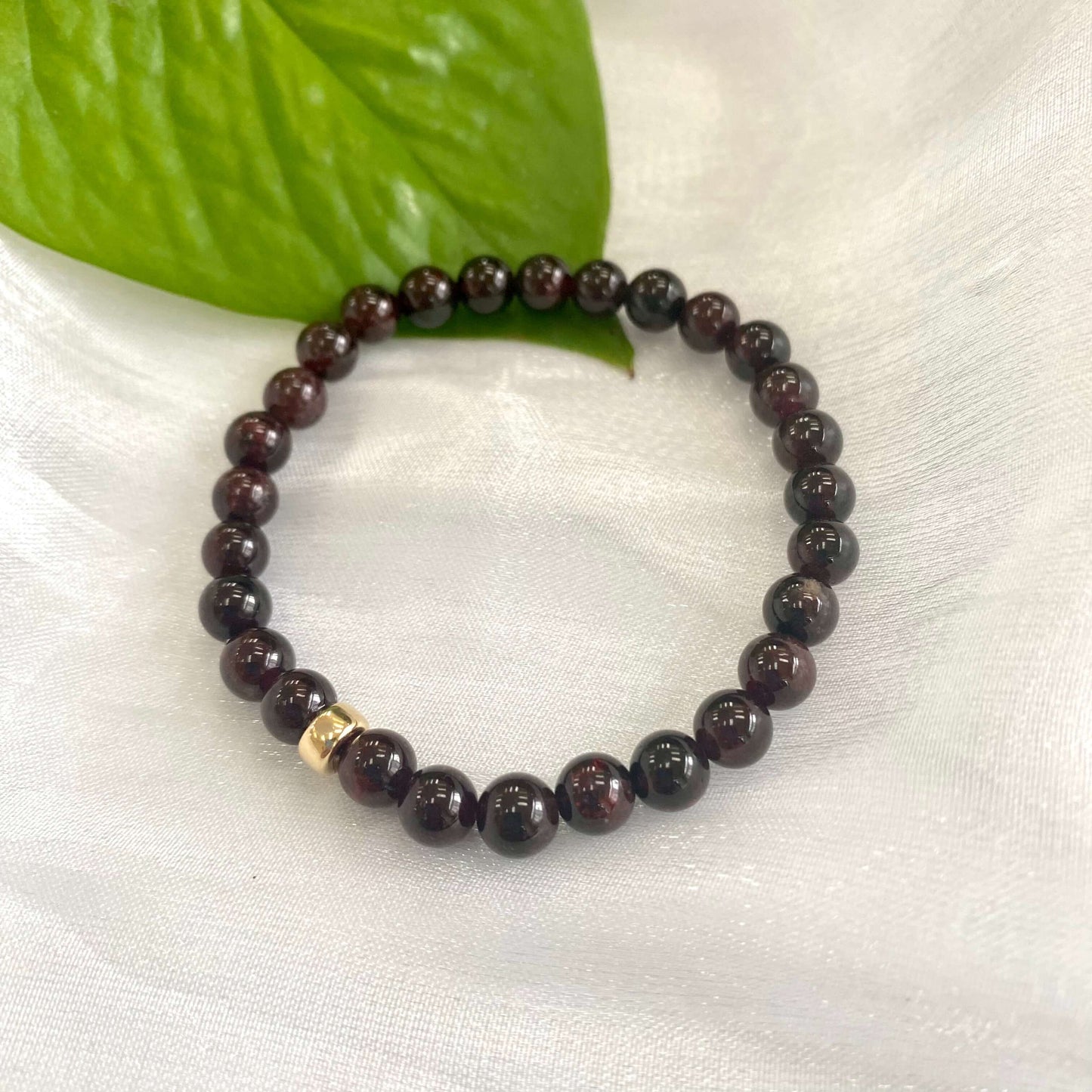 Dark Red Garnet Bracelet close-up on white cloth – single bracelet detail