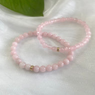 Rose quartz stretch bracelet featuring 6mm beads and 14K gold filled accents, perfect for layering or solo wear.