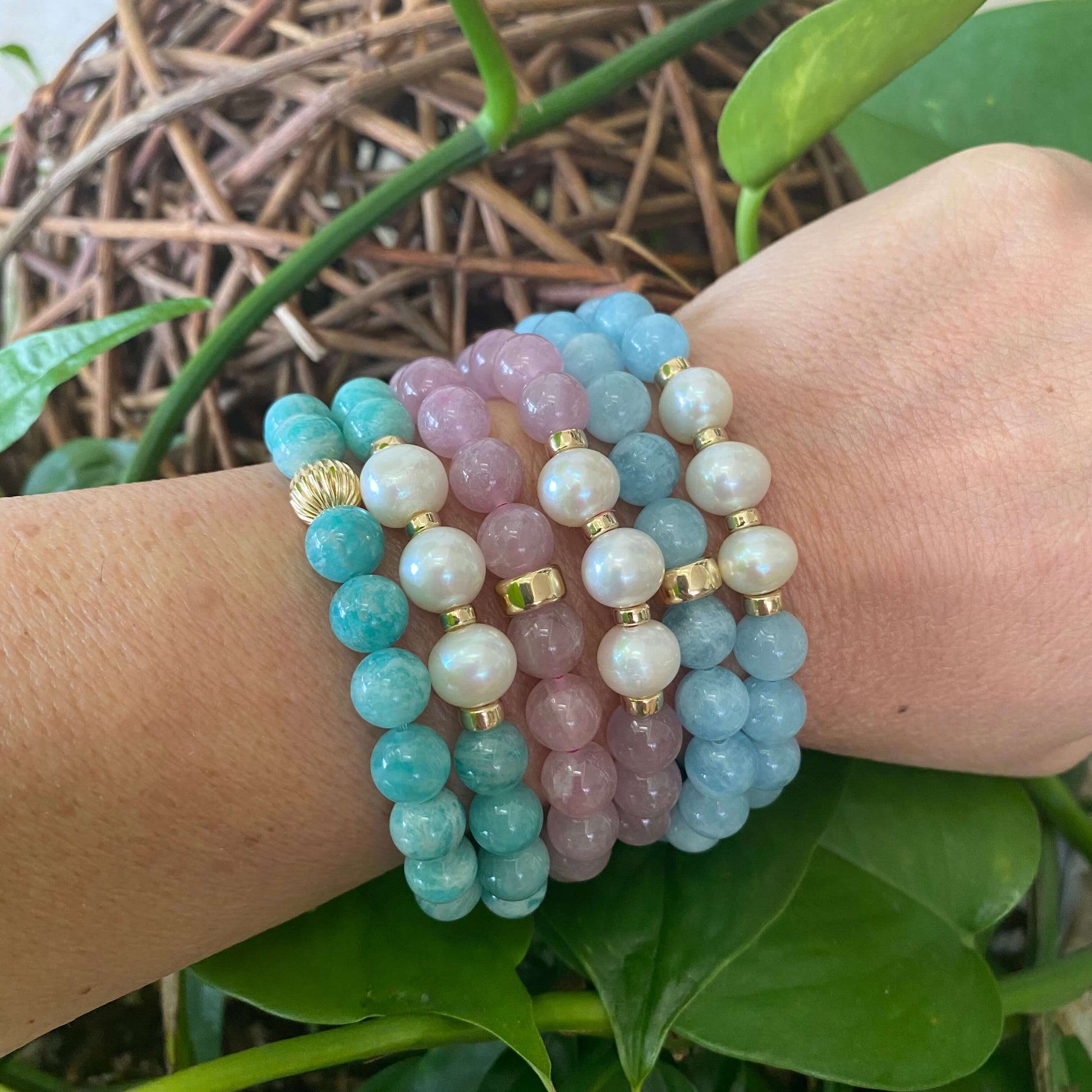 Rose Quartz Pearl Bracelet worn with other bracelets on model’s wrist – mixed stack shot