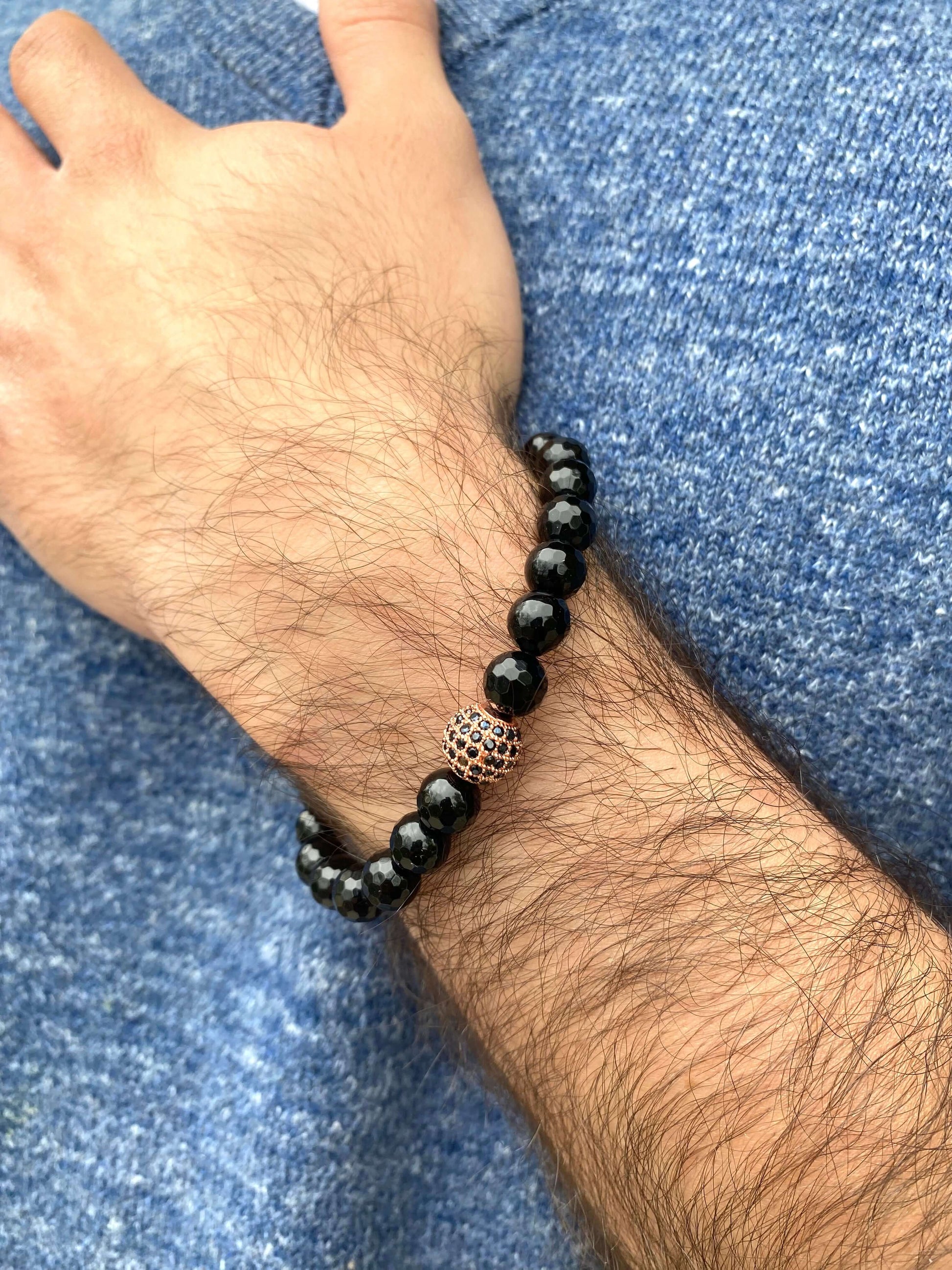 Black Onyx Mens Bracelet – Stretch Design with Rose Gold Accents worn on a male wrist