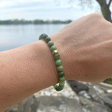 Load image into Gallery viewer, Chrysoprase stretch bracelet with 6mm beads and 14K gold filled accents worn outdoors by a lake.
