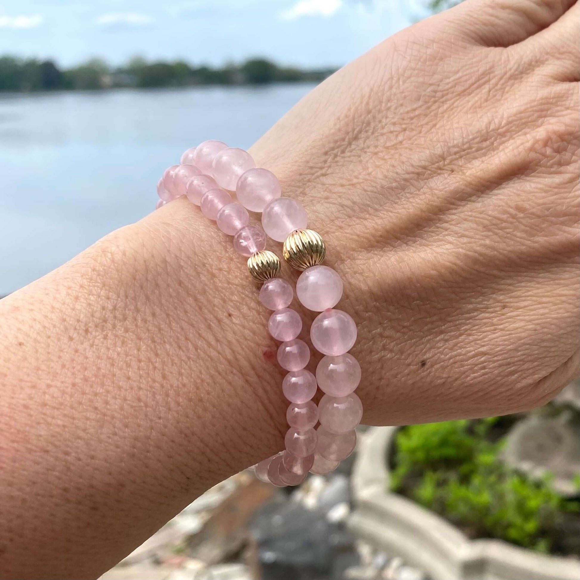 Rose Quartz Bracelet worn on woman’s wrist – stacked natural light shot