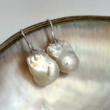 Charger l&#39;image dans la galerie, Baroque pearl drop earrings photographed on white pearl background – silver finish
