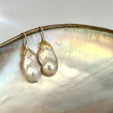 Charger l&#39;image dans la galerie, Gold baroque pearl drop earrings close-up on white pearl backdrop – lustrous handcrafted jewelry
