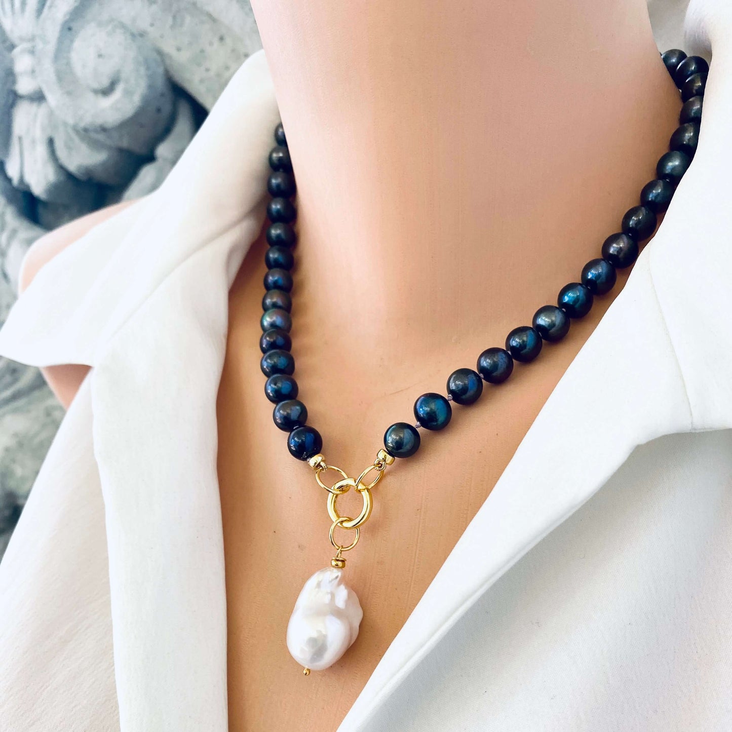 Black pearl necklace with baroque pendant displayed on mannequin with white pearl pendant