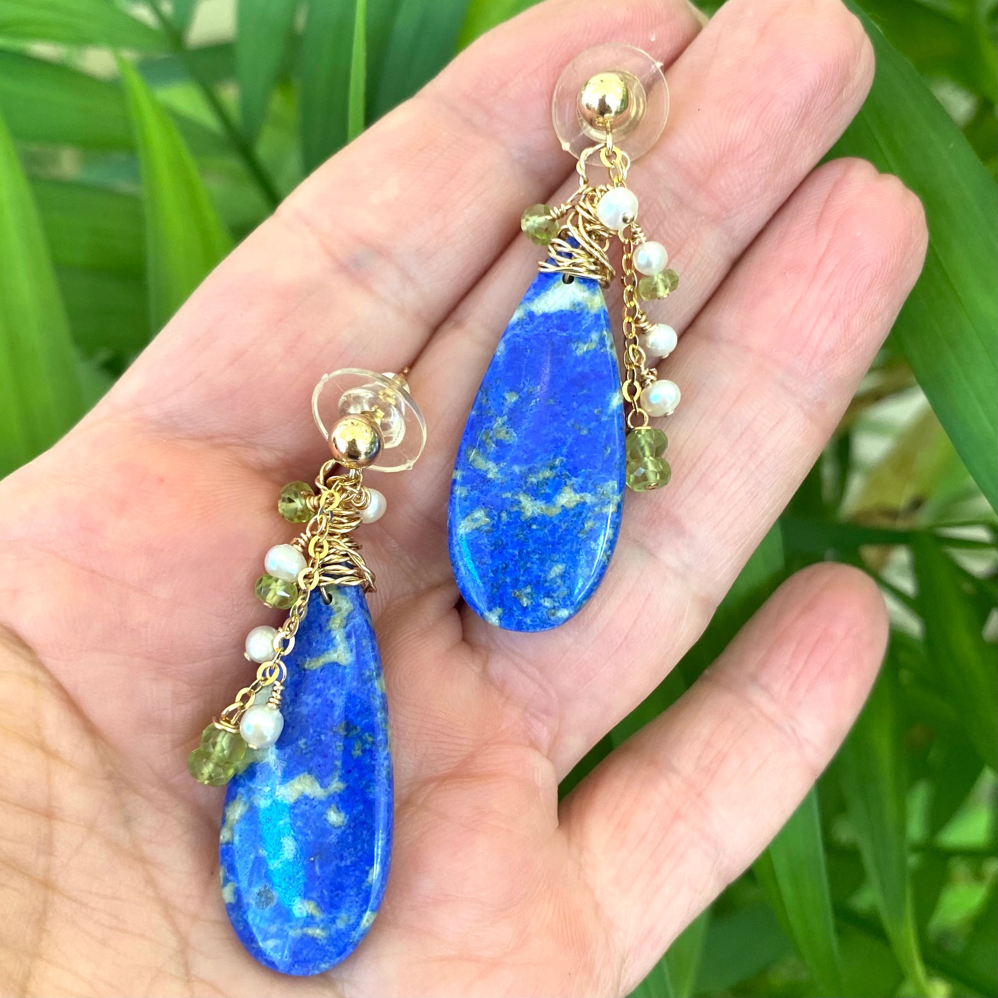 Lapis Lazuli Peridot Earrings - Teardrop 14k Gold Filled displayed in hand, showcasing unique gemstones and elegant design.