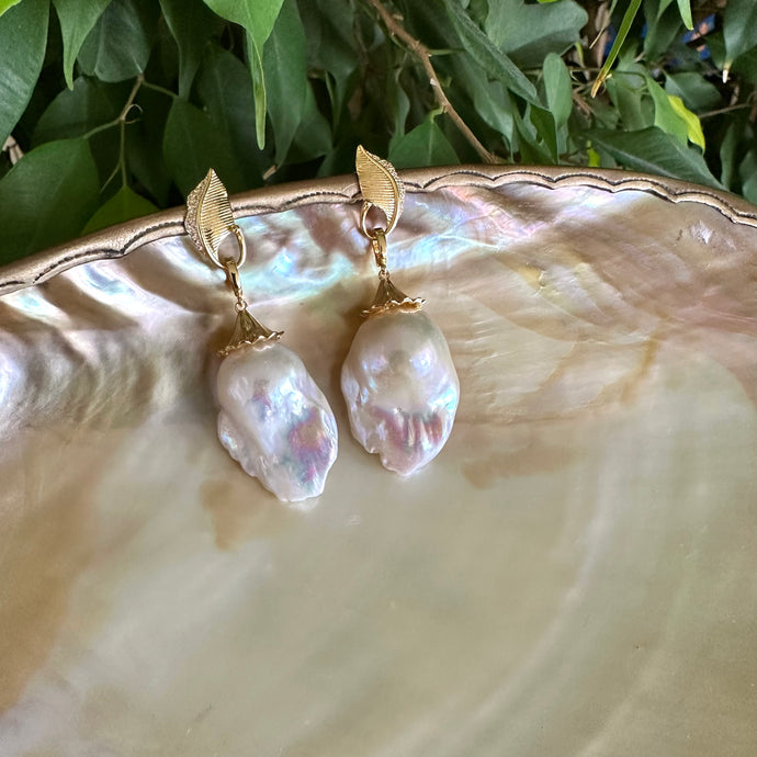 Leaf Design Pearl Earrings featuring gold vermeil leaf accents and genuine baroque pearl drops on a shell background.