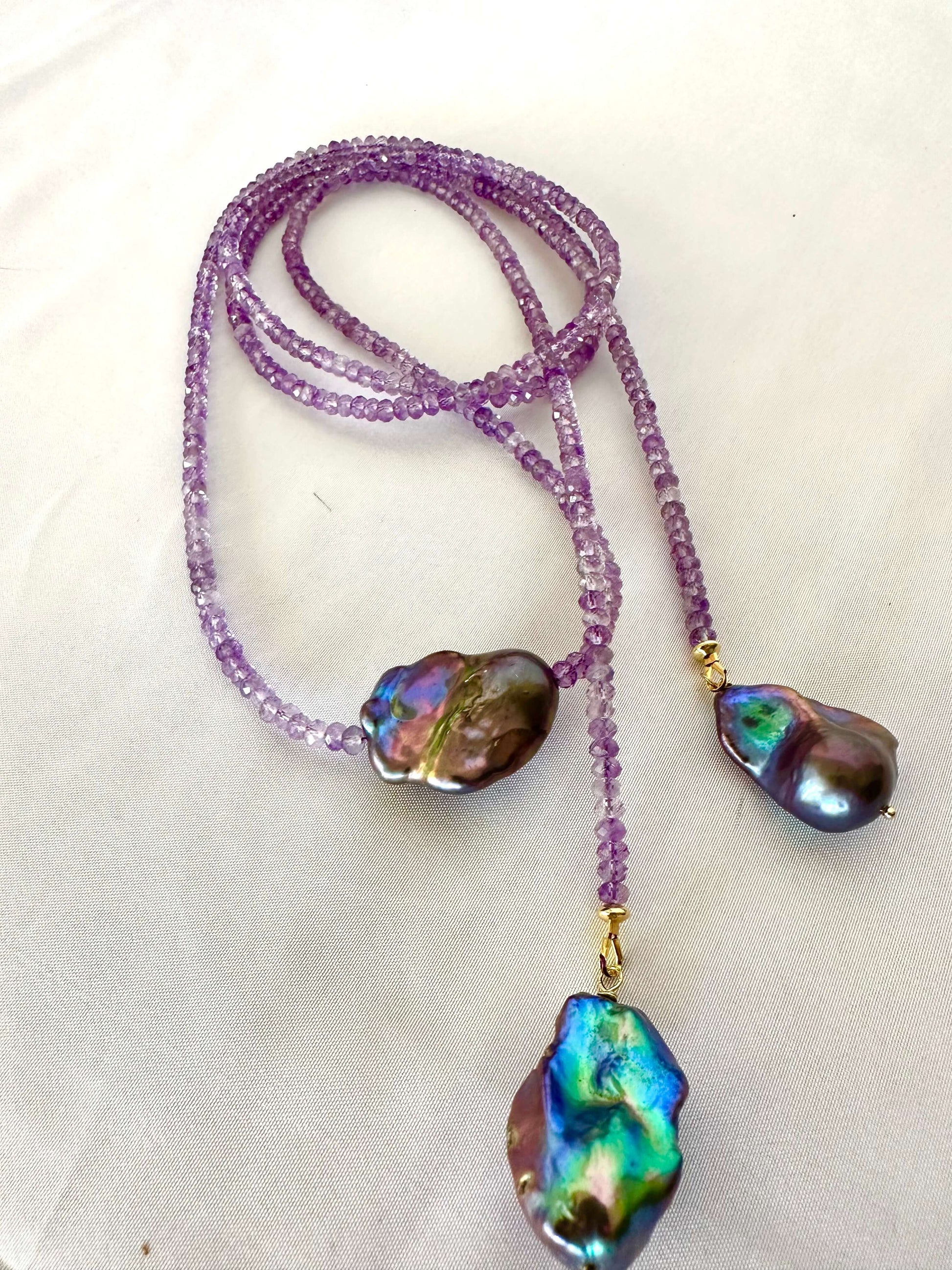 Close-up of Amethyst and Black Baroque Pearl Lariat Necklace on white background — faceted amethyst beads and baroque pearls handcrafted by Loulia Pearl Jewelry