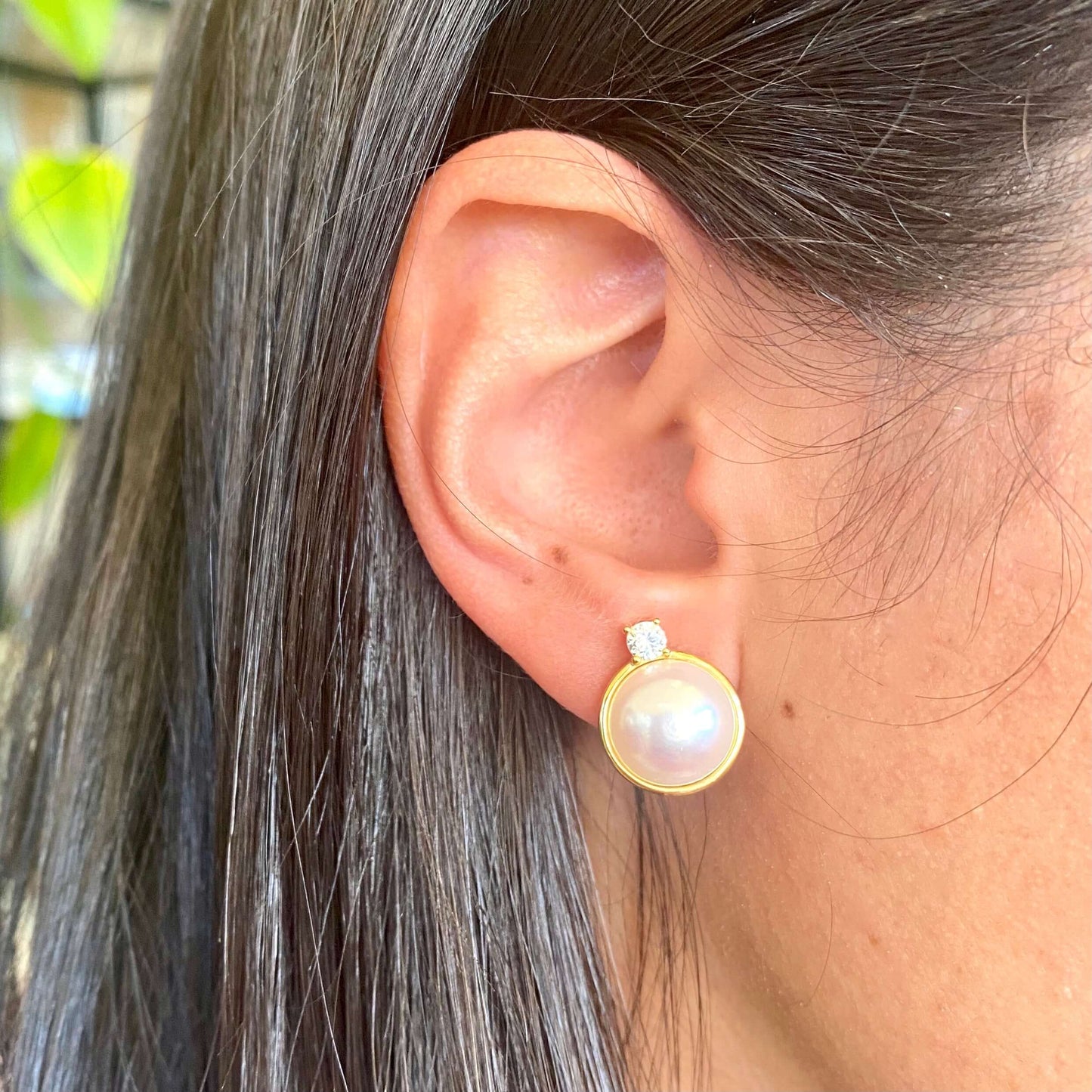 Model wearing pink mabe pearl stud earrings with CZ in sterling silver, side profile showing soft pink hue and elegant fit.