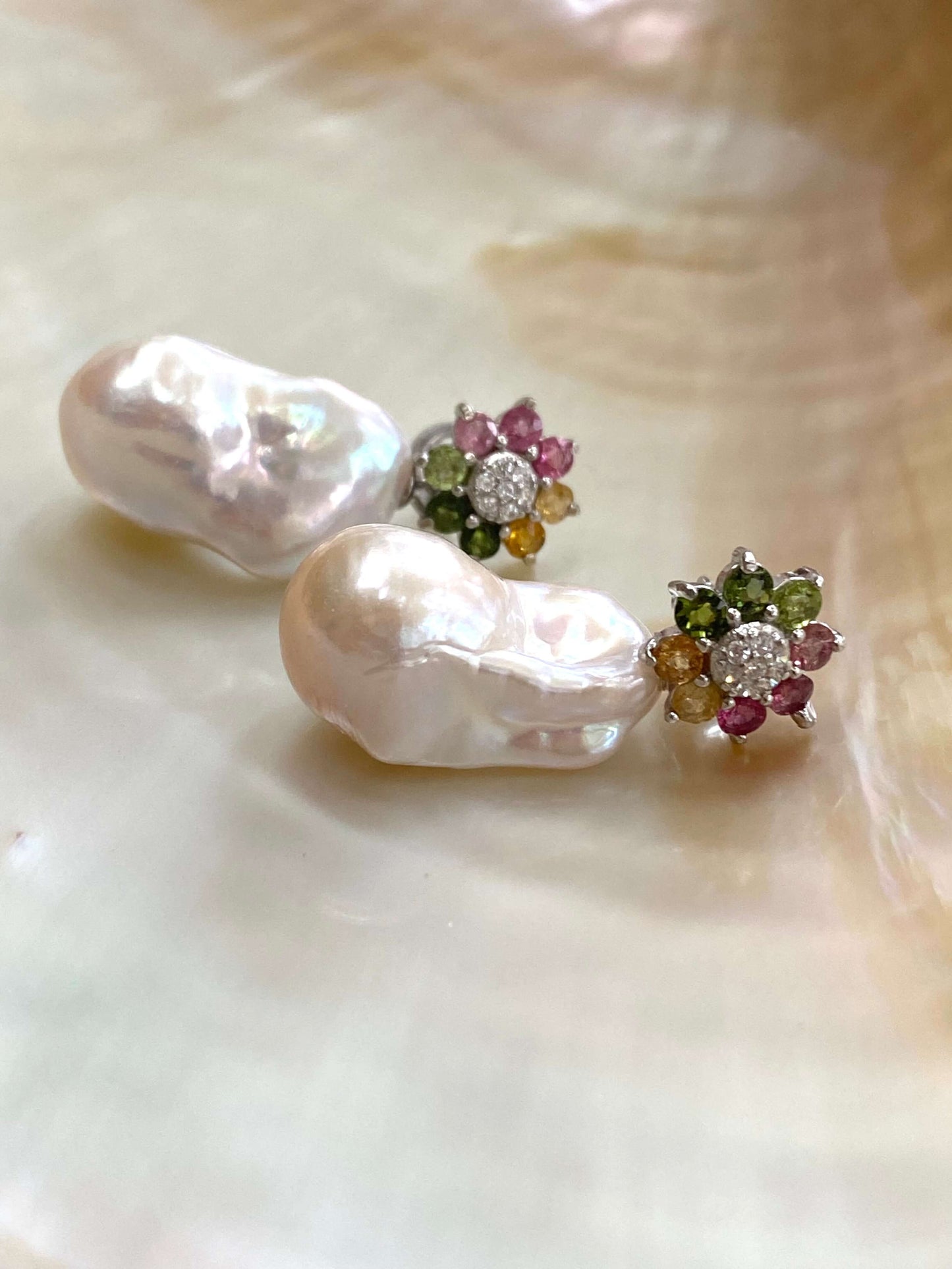 Handmade tourmaline pearl earrings with colorful gemstone flower studs and baroque pearls on white background